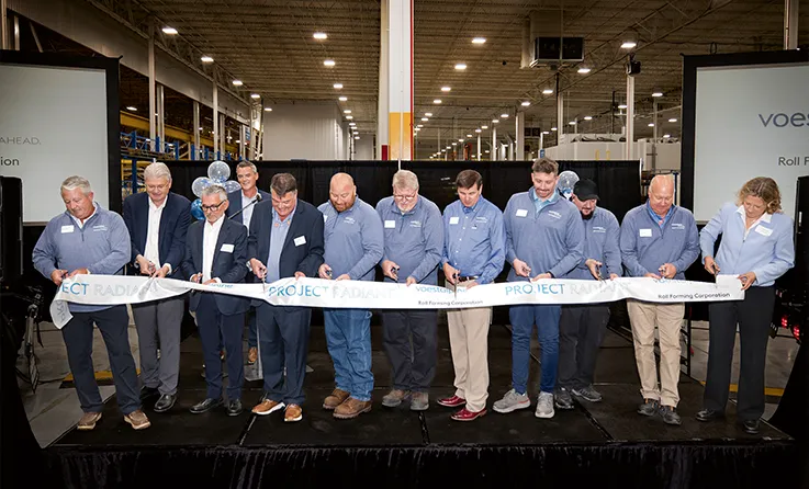 A ceremonial ribbon-cutting attended by several people to mark the opening of ‘Project Radiant’ in a factory hall (photo)